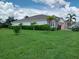Well-manicured lawn and tasteful landscaping enhance the curb appeal of this beautiful single-Gathering home at 25224 Lahore Ln, Punta Gorda, FL 33983