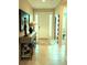 Inviting foyer featuring neutral tile flooring, console table with decorative accents, and a bright front door at 25224 Lahore Ln, Punta Gorda, FL 33983