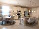 Bright and airy kitchen with white cabinetry, stainless steel appliances, and an island with bar seating at 25224 Lahore Ln, Punta Gorda, FL 33983