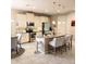 Bright kitchen island features pendant lighting, bar stool seating and modern appliances in an open-concept design at 25224 Lahore Ln, Punta Gorda, FL 33983