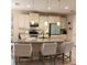 Well-lit kitchen island with pendant lights, bar stools, granite counters and modern appliances, a chef's dream at 25224 Lahore Ln, Punta Gorda, FL 33983