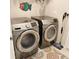 Modern laundry room features Samsung front-load washer and dryer, with a bright patterned rug at 25224 Lahore Ln, Punta Gorda, FL 33983