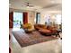Spacious living room featuring a leather sectional sofa, patterned rug, and a sliding glass door to outdoor patio at 25224 Lahore Ln, Punta Gorda, FL 33983