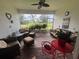 Cozy sunroom filled with wicker furniture and plants creating a comfortable outdoor space at 25224 Lahore Ln, Punta Gorda, FL 33983