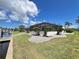 Back yard view showing lawn, foliage, and screened patio at 2526 Brazilia Ct, Punta Gorda, FL 33950