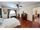 Cozy bedroom with wood floors, ceiling fan, and bright window at 2526 Brazilia Ct, Punta Gorda, FL 33950