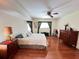 Spacious bedroom with wood floors, ceiling fan, and bright window at 2526 Brazilia Ct, Punta Gorda, FL 33950