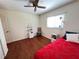 Cozy bedroom with wood floors, ceiling fan, and bright window at 2526 Brazilia Ct, Punta Gorda, FL 33950