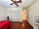 Cozy bedroom with wood floors, ceiling fan, and bright window at 2526 Brazilia Ct, Punta Gorda, FL 33950