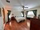 Spacious bedroom with wood floors, ceiling fan, and bright window at 2526 Brazilia Ct, Punta Gorda, FL 33950
