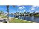 Waterfront views of the canal from the yard with a boat lift and beautiful landscaping at 2526 Brazilia Ct, Punta Gorda, FL 33950