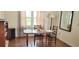 Cozy dining area featuring hardwood floors and a window letting in natural light at 2526 Brazilia Ct, Punta Gorda, FL 33950