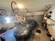 Spacious garage with a gray car parked inside, storage on walls, and a door leading outside at 2526 Brazilia Ct, Punta Gorda, FL 33950