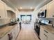 Modern kitchen showcasing white cabinets, stainless steel appliances, and granite countertops at 2526 Brazilia Ct, Punta Gorda, FL 33950