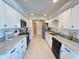 Updated kitchen with white cabinets, stainless steel appliances, and granite countertops at 2526 Brazilia Ct, Punta Gorda, FL 33950