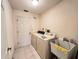 Laundry room with white appliances, tiled floor, and utility sink at 2526 Brazilia Ct, Punta Gorda, FL 33950