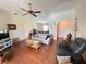 Bright living room featuring hardwood floors, a ceiling fan, and comfortable seating at 2526 Brazilia Ct, Punta Gorda, FL 33950