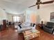 Cozy living room with hardwood floors, a ceiling fan, and lots of natural light at 2526 Brazilia Ct, Punta Gorda, FL 33950