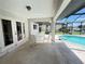 Covered patio with table and chairs overlooking pool and waterfront at 2526 Brazilia Ct, Punta Gorda, FL 33950