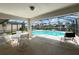 Screened in patio with waterfront views and seating area near pool at 2526 Brazilia Ct, Punta Gorda, FL 33950
