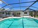 Sparkling in-ground pool within a screened enclosure, perfect for relaxation at 2526 Brazilia Ct, Punta Gorda, FL 33950