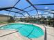Sparkling in-ground pool with enclosure and waterfront views at 2526 Brazilia Ct, Punta Gorda, FL 33950