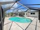 Backyard features a pool with screened enclosure overlooking a canal at 2526 Brazilia Ct, Punta Gorda, FL 33950