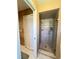 Tiled walk-in shower with glass door and a white bifold door leading to the toilet area of the Primary bath at 2526 Brazilia Ct, Punta Gorda, FL 33950