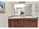 Bright bathroom featuring a double vanity sink and glass door shower enclosure at 25272 E Lenox Cir, Punta Gorda, FL 33950