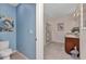 Bathroom with ceramic tile floors features a single vanity and a glass enclosed shower at 25272 E Lenox Cir, Punta Gorda, FL 33950