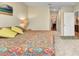 Bedroom with ensuite bathroom features carpeted floors and a colorful bedspread at 25272 E Lenox Cir, Punta Gorda, FL 33950