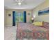 Bedroom with ensuite bathroom features carpeted floors and a colorful bedspread at 25272 E Lenox Cir, Punta Gorda, FL 33950