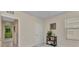 Comfortable bedroom with stylish black shelf and plants, featuring neutral carpeting, light walls, and ample natural light at 25272 E Lenox Cir, Punta Gorda, FL 33950