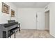 Clean bedroom with piano, featuring neutral carpeting, light walls, and ample natural light, creating a serene atmosphere at 25272 E Lenox Cir, Punta Gorda, FL 33950