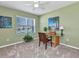 Neutral-toned bedroom featuring a window with blinds, desk, ceiling fan and topical themed decorations at 25272 E Lenox Cir, Punta Gorda, FL 33950