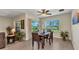 Well-lit dining area with modern wooden furniture and windows providing natural light at 25272 E Lenox Cir, Punta Gorda, FL 33950