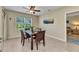 Charming dining area with wood table and chairs, bright window, and a view of the yard at 25272 E Lenox Cir, Punta Gorda, FL 33950