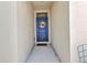 A welcoming front entrance featuring a stylish blue door with a decorative wreath and a clean, bright entryway at 25272 E Lenox Cir, Punta Gorda, FL 33950