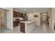 Bright kitchen with wooden cabinets, center island with sink, and an open layout to the entry way at 25272 E Lenox Cir, Punta Gorda, FL 33950