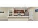 Modern kitchen features a center island with sink, stainless appliances, and plenty of natural light at 25272 E Lenox Cir, Punta Gorda, FL 33950