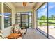 Enclosed lanai featuring comfortable seating and a beautiful view of the landscaped backyard at 25272 E Lenox Cir, Punta Gorda, FL 33950