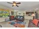Inviting living room showcases an open layout, leather furniture, and connection to the dining area at 25272 E Lenox Cir, Punta Gorda, FL 33950