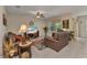 Cozy living room featuring comfortable leather furniture and bright natural light at 25272 E Lenox Cir, Punta Gorda, FL 33950