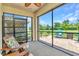 Screened-in patio with furniture and view of backyard at 25272 E Lenox Cir, Punta Gorda, FL 33950
