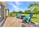 Paver patio featuring comfortable seating with a serene backyard view, ideal for relaxation and entertaining at 25272 E Lenox Cir, Punta Gorda, FL 33950