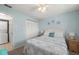 This is a relaxing bedroom featuring a queen-size bed, light blue walls, and natural light at 25275 Rampart Blvd # 404, Punta Gorda, FL 33983