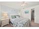 Bright bedroom featuring a queen bed, a ceiling fan, and an open closet at 25275 Rampart Blvd # 404, Punta Gorda, FL 33983