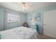 Bright bedroom with a ceiling fan, neutral walls, and plenty of natural light from the window at 25275 Rampart Blvd # 404, Punta Gorda, FL 33983