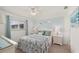 Bedroom features a queen bed, a ceiling fan, and a window with natural light at 25275 Rampart Blvd # 404, Punta Gorda, FL 33983