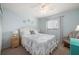Bedroom features a queen bed, nightstands, and a ceiling fan at 25275 Rampart Blvd # 404, Punta Gorda, FL 33983